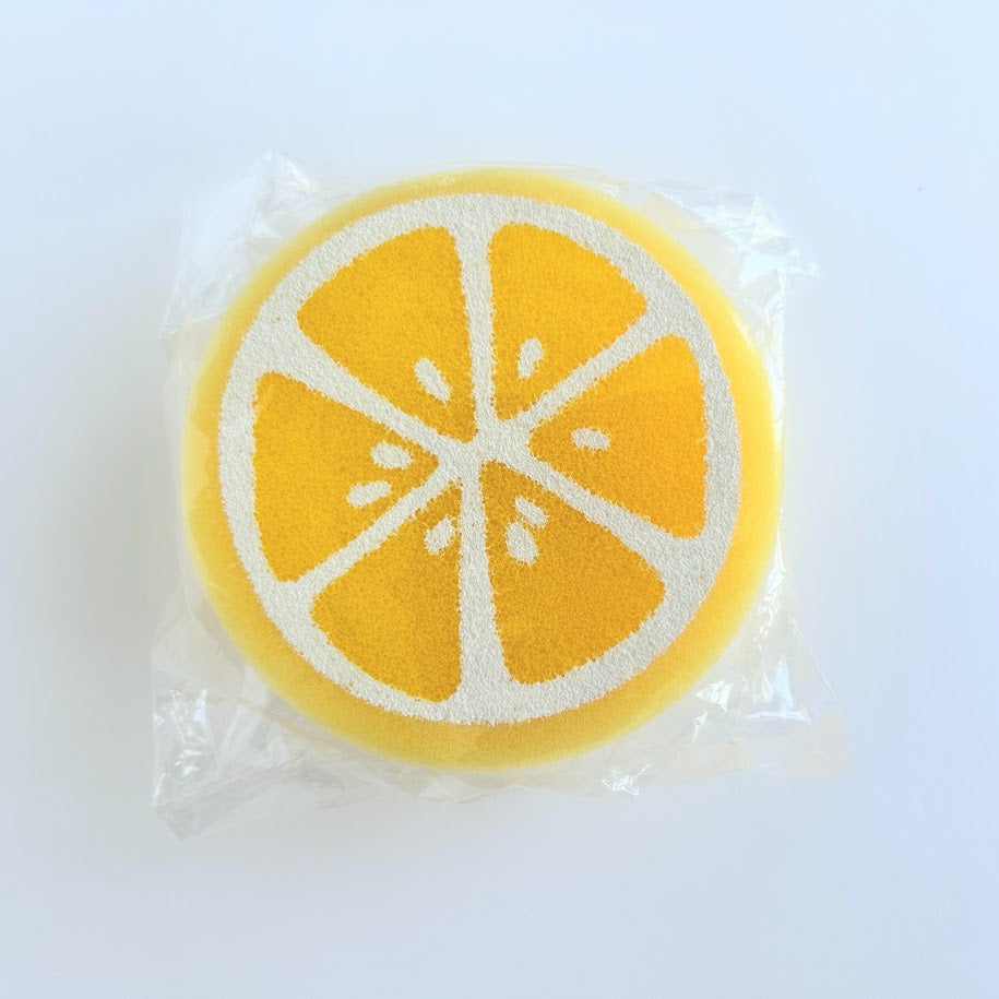 Yellow lemon-shaped sponge for kitchen cleaning with citrus slice design