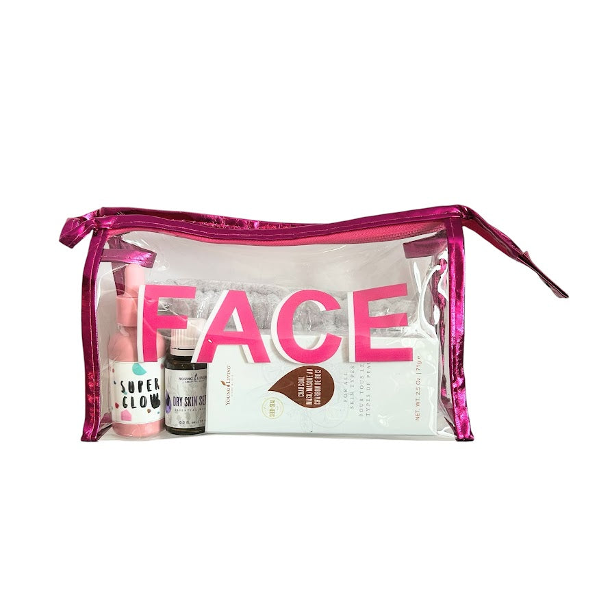 Pink clear FACE wellness bag filled with skincare products including glow serum and charcoal face mask.