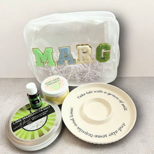 Margarita wellness gift bundle with lime margarita salt, body scrub, lime essential oil, ceramic salt rimmer, and reusable gift pouch.