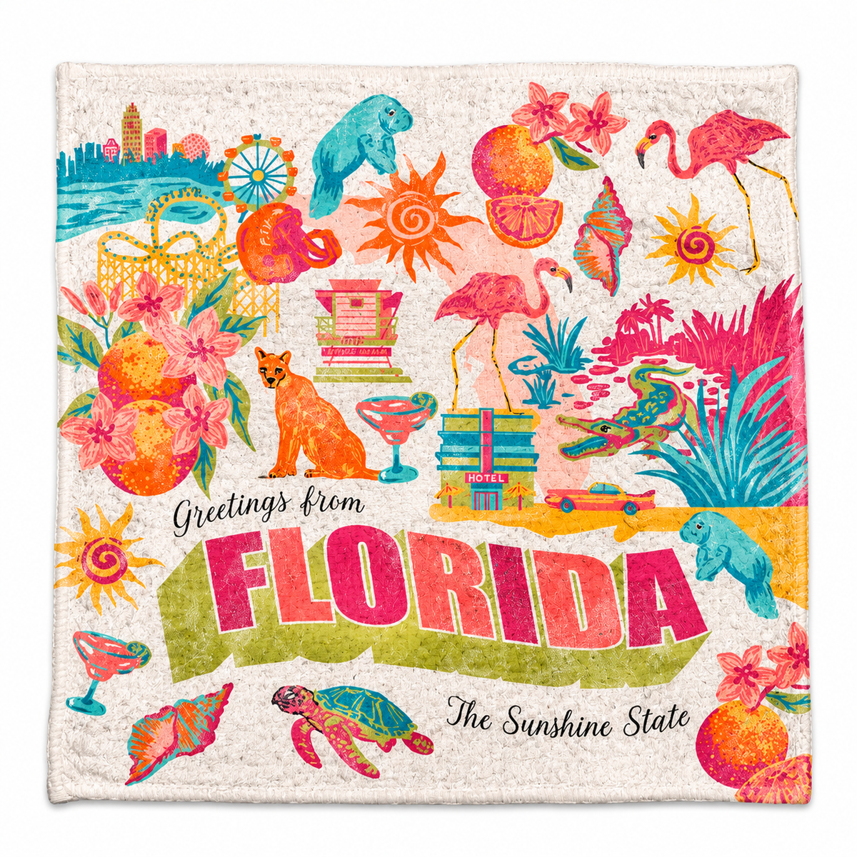 Colorful Florida souvenir towel featuring retro-style illustrations of flamingos, manatees, oranges, palm trees, seashells, and coastal landmarks, with “Greetings from Florida” and “The Sunshine State” lettering.