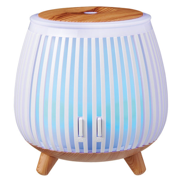 Blue and white essential oil diffuser with wood accents included in the Vinyl & Oil graduation wellness gift bundle.