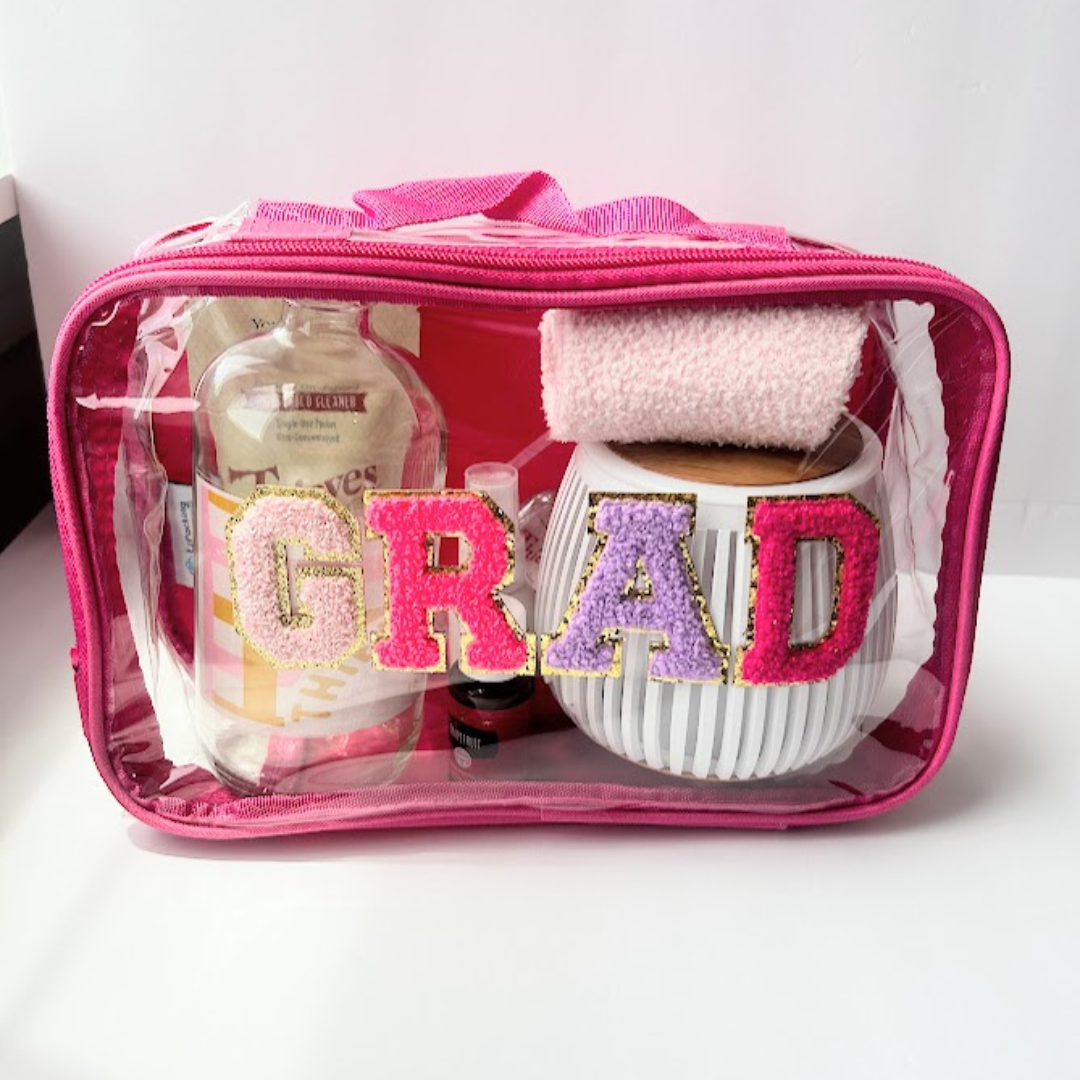 Self-care graduation gift bag with diffuser, wellness essentials, reusable clear grad pouch, and cozy socks for college students or graduates.