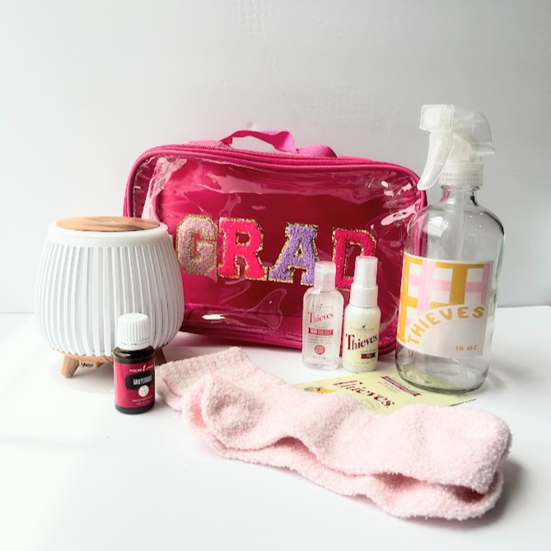 Graduation wellness gift bundle with diffuser, essential oils, Thieves wellness products, reusable grad pouch, and cozy socks for high school or college graduates.