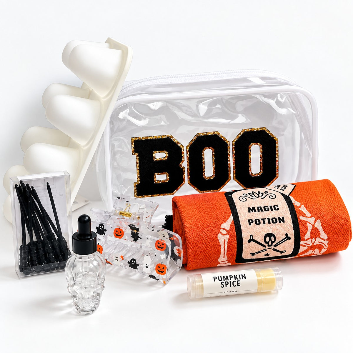 Black BOO Halloween Wellness Gift Bundle with orange Magic Potion towel, pumpkin spice lip balm, skull bottle, ice mold and Halloween accessories
