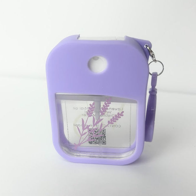 Lavender Travel Spray with calming essential oils in a refillable travel bottle with silicone clip for purses, backpacks, and travel.