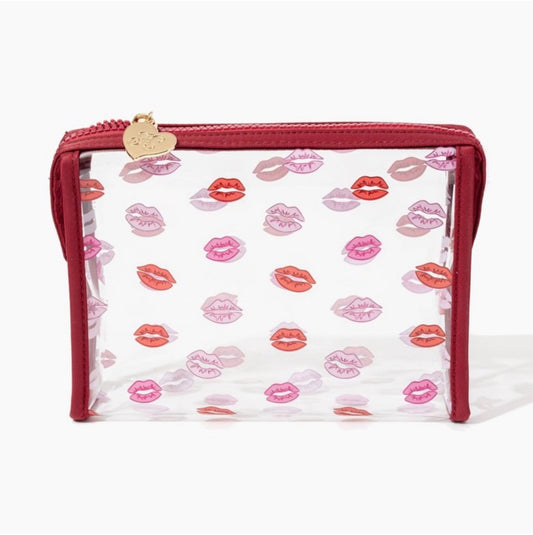 Clear vinyl cosmetic bag with pink and red lip print design and red zipper trim