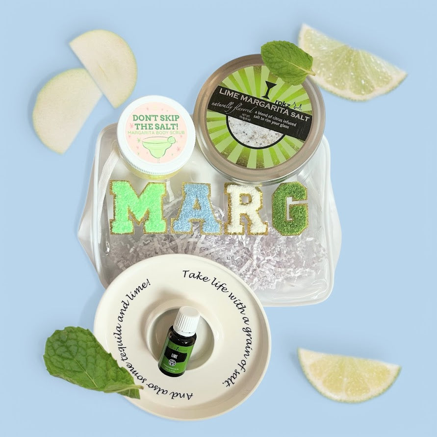 Margarita gift bundle arranged with margarita salt, lime essential oil, body scrub, ceramic salt rimmer, and reusable gift pouch for birthdays, hostesses, and girls' trips.