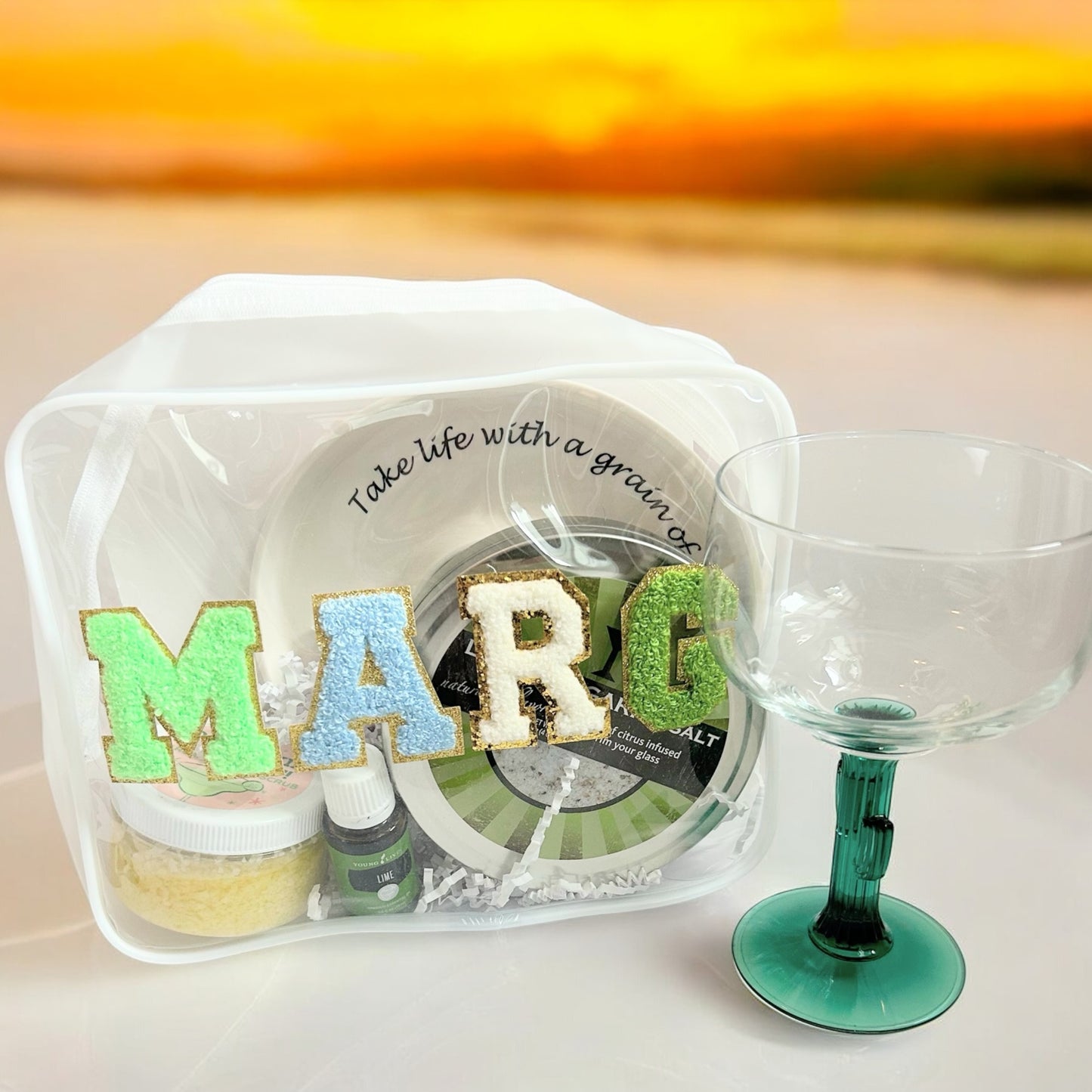Marg Wellness Gift Bundle styled for happy hour with a reusable gift pouch, lime margarita salt, margarita body scrub, lime essential oil, ceramic salt rimmer, and margarita glass—perfect for hostess gifts, girls' trips, birthdays, and vacation gifting.