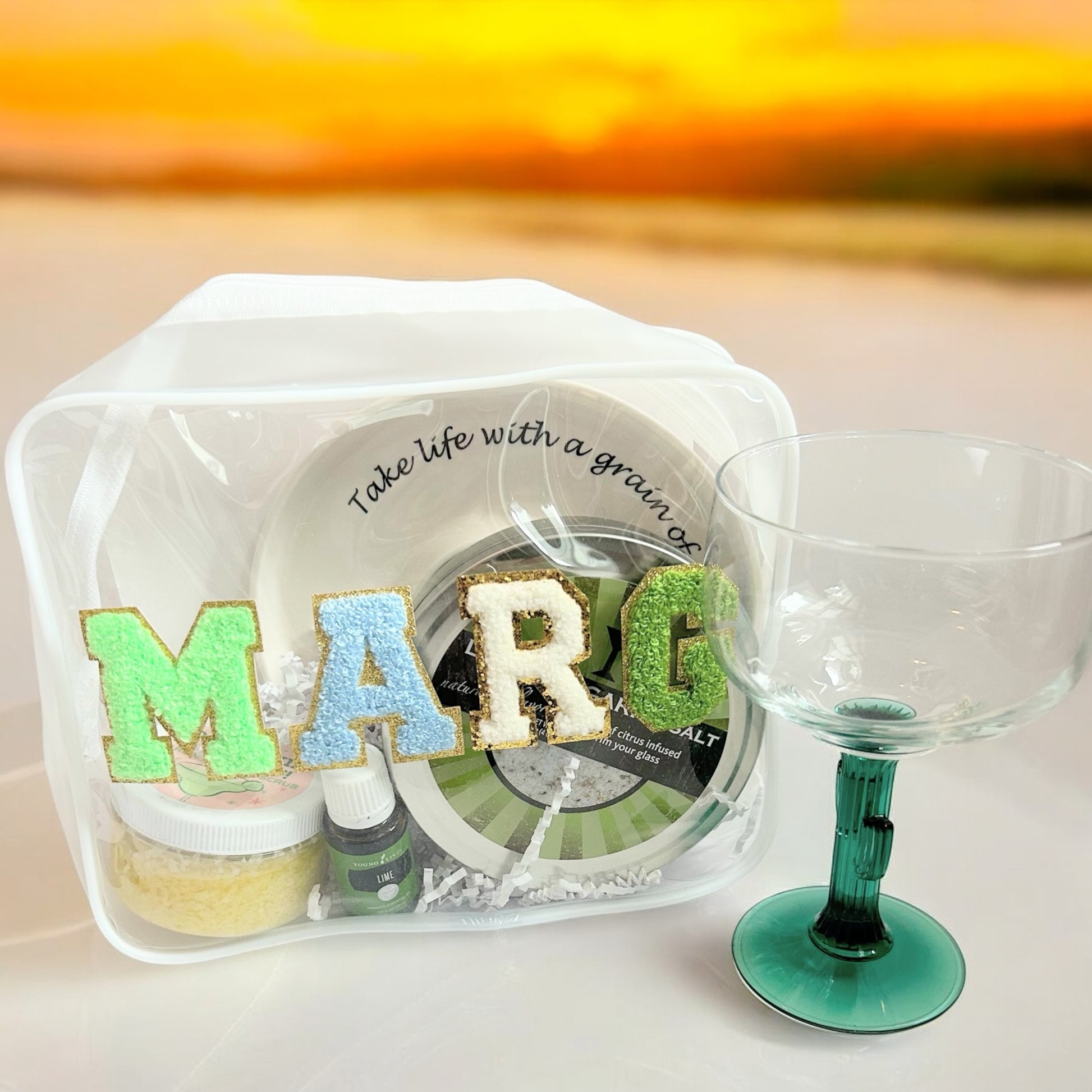 Marg Wellness Gift Bundle styled for happy hour with a reusable gift pouch, lime margarita salt, margarita body scrub, lime essential oil, ceramic salt rimmer, and margarita glass—perfect for hostess gifts, girls' trips, birthdays, and vacation gifting.