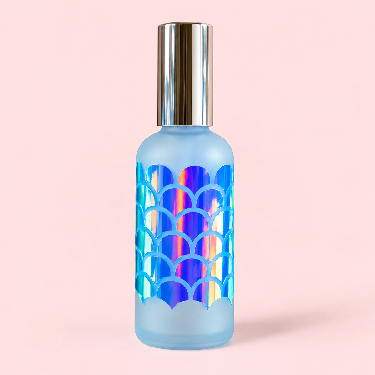 Mermaid Hair Detangler Spray in a frosted blue glass bottle with iridescent mermaid-scale design by Vinyl & Oil.