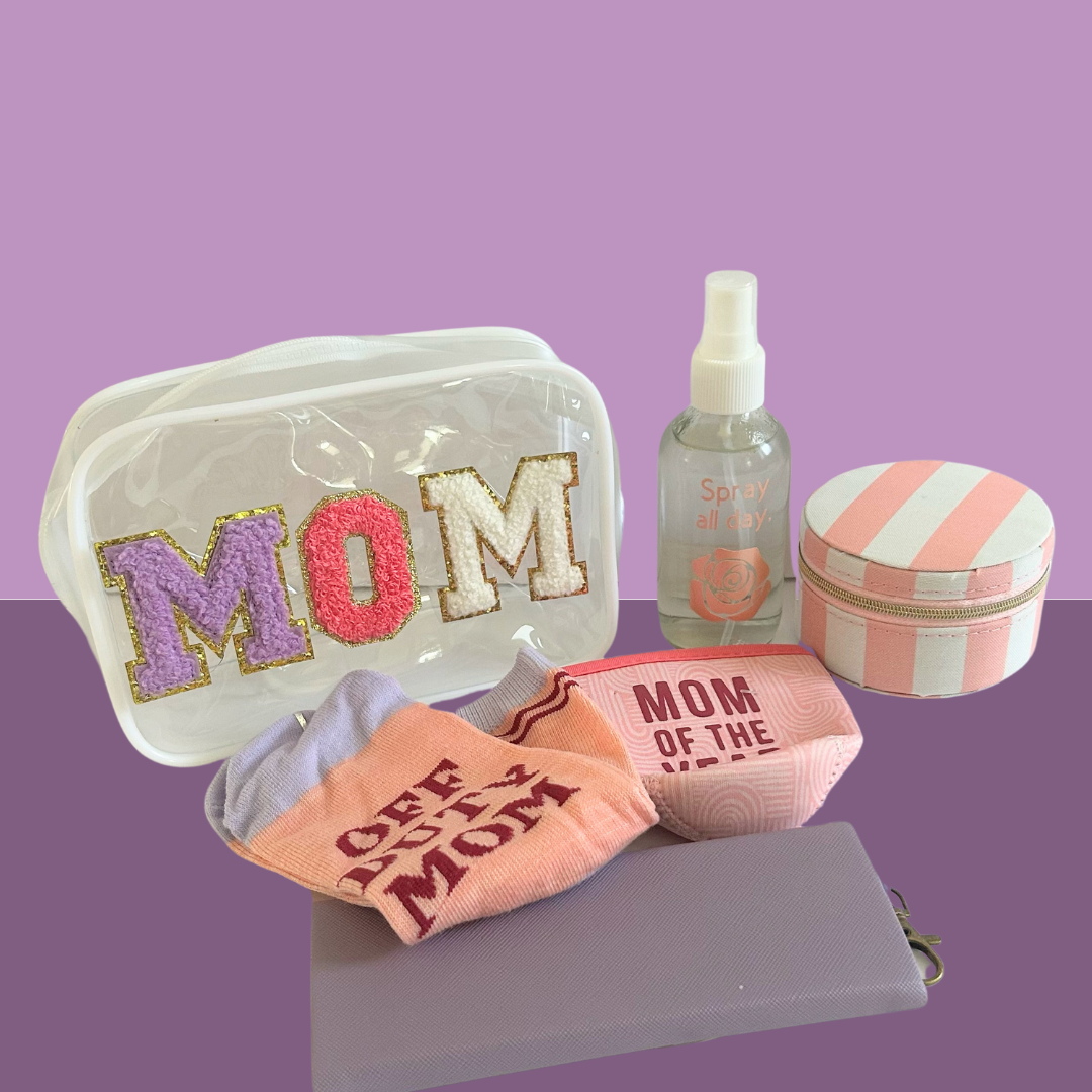 Mom self-care gift bundle with wellness accessories, cosmetic bags, and relaxing lifestyle products on a lavender background.