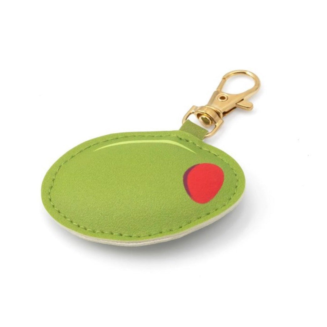 Angled view of olive bag charm featuring a gold lobster clasp and playful martini-inspired design.
