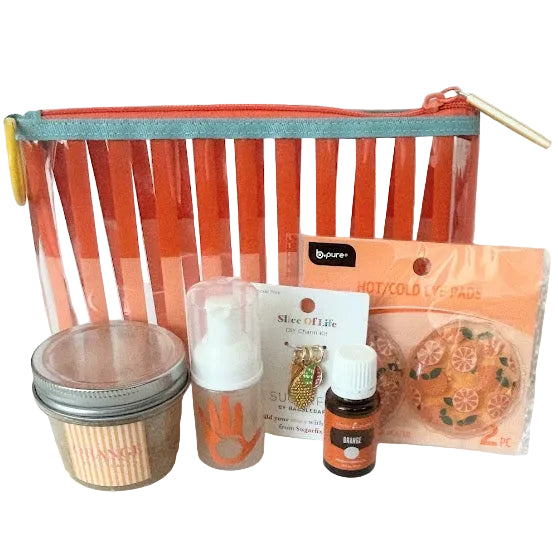 Coral and orange striped reusable bag filled with citrus wellness and self-care gifts