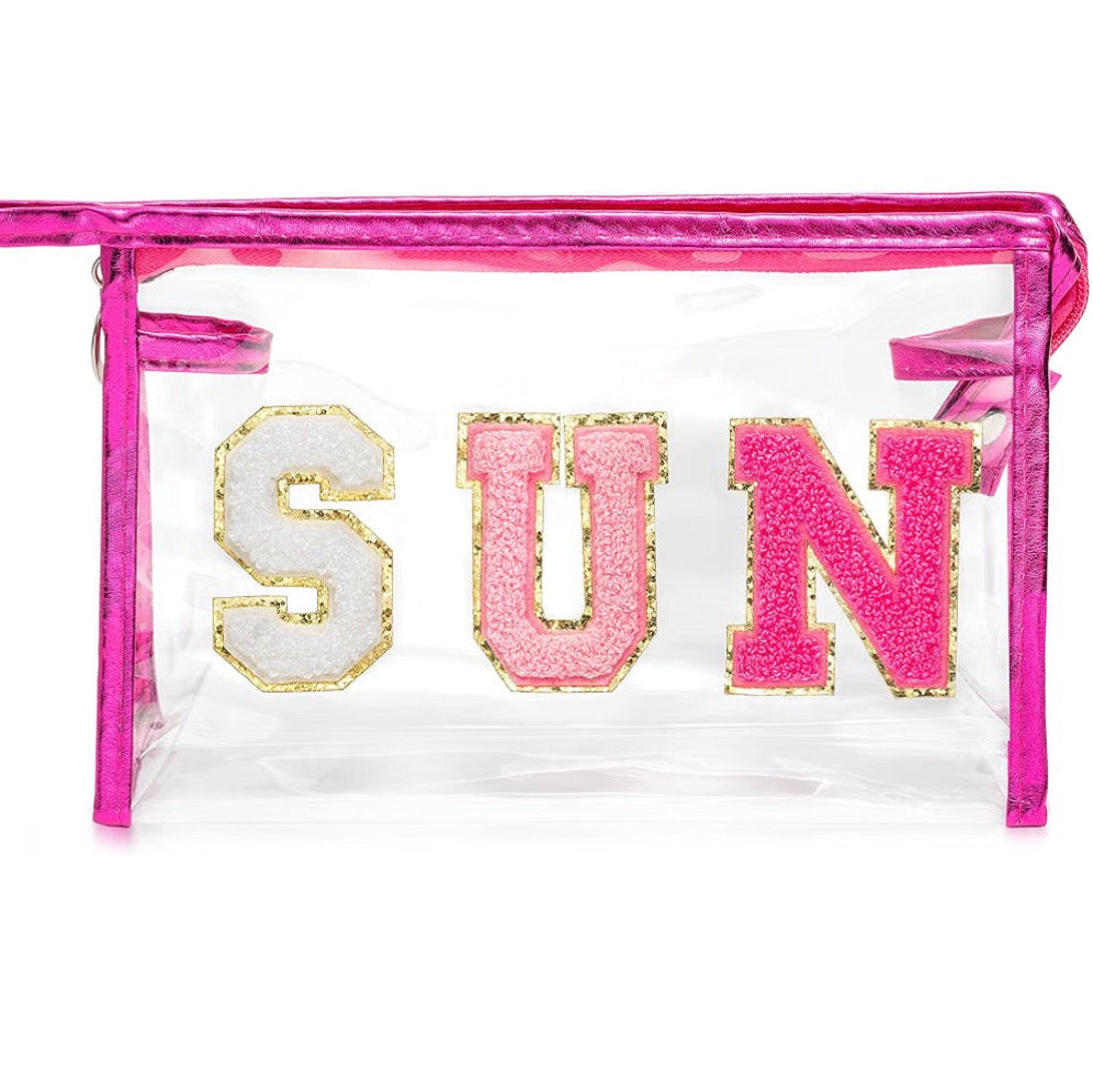 Clear cosmetic bag with metallic pink trim and colorful SUN lettering