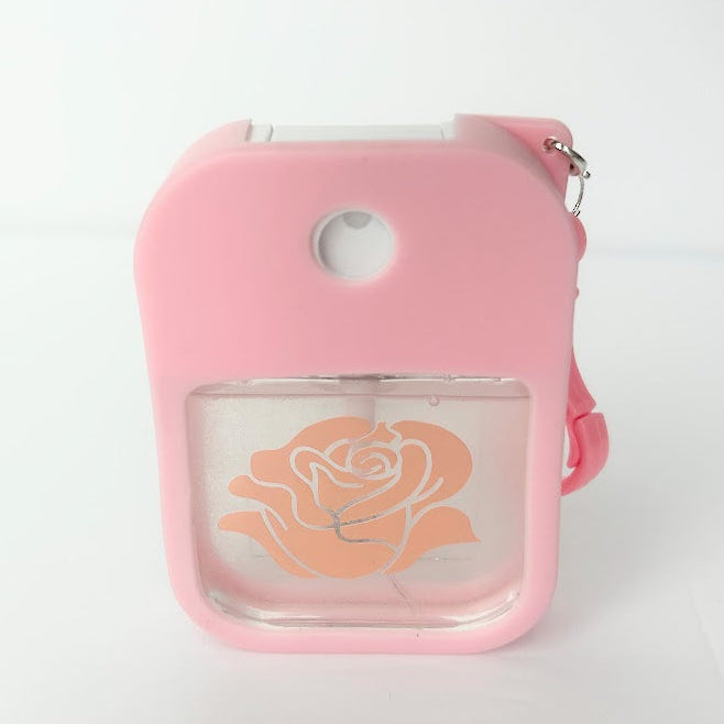 Rose Travel Spray that refreshes and hydrates skin in a refillable travel bottle with silicone clip for wellness on the go.