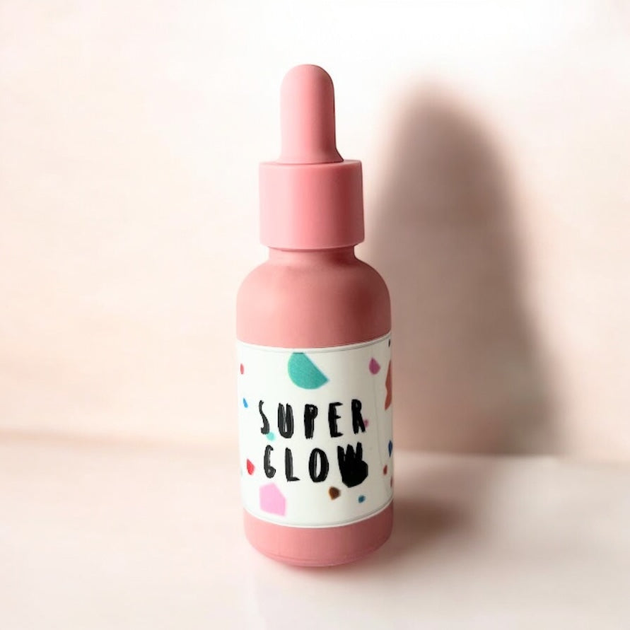 Super Glow face serum with essential oils and natural skincare ingredients for glowing skin and wellness routines.