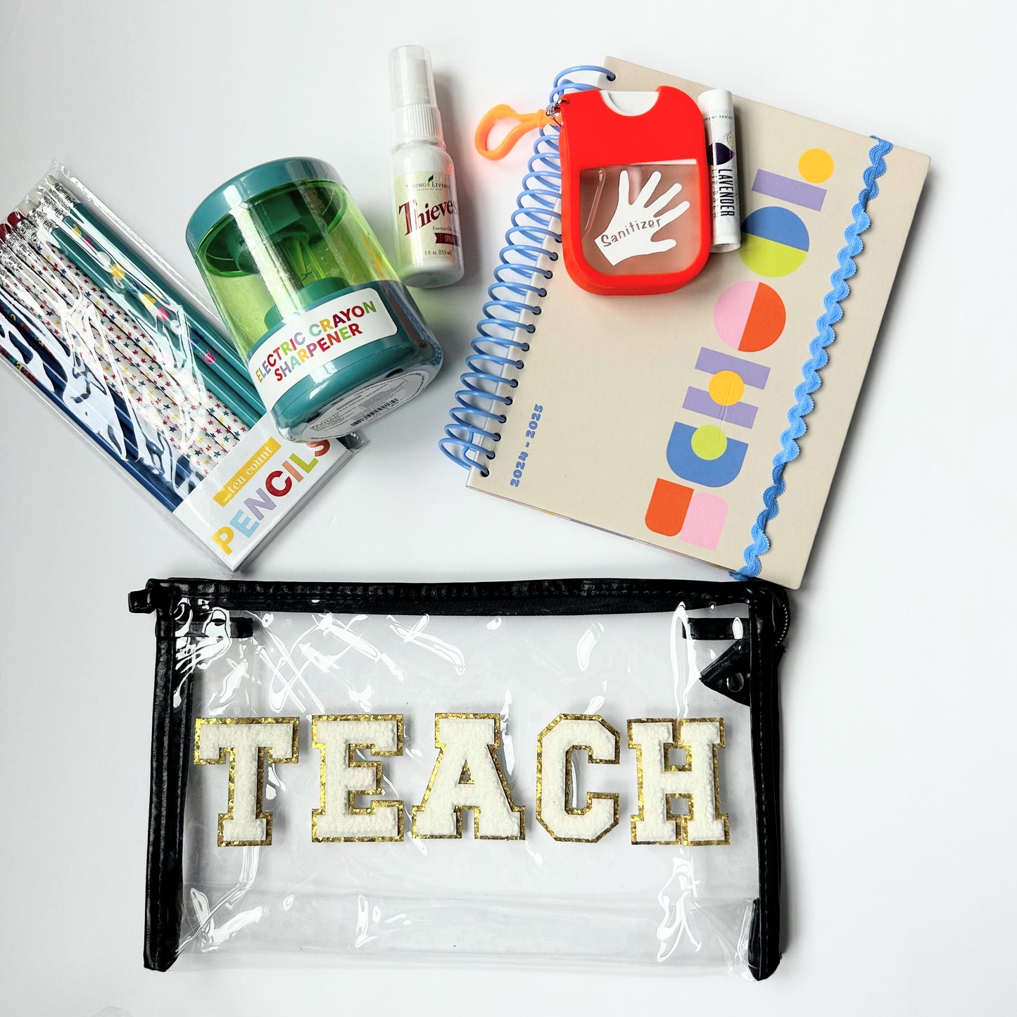 Teacher gift bundle with black TEACH bag, colorful notebook, classroom supplies and wellness gifts