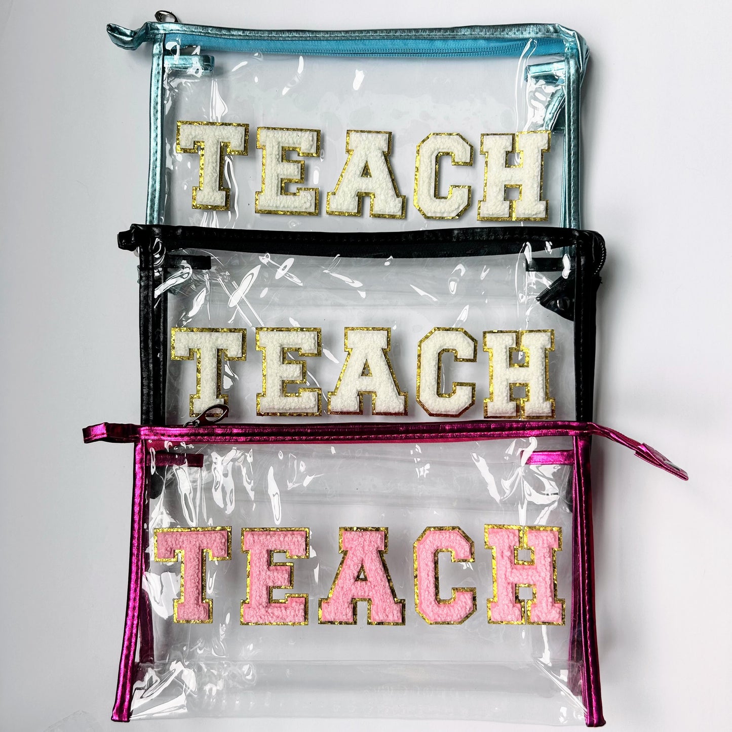 Clear TEACH gift bags in teal, black and pink available with the Teacher Wellness Gift Bundle